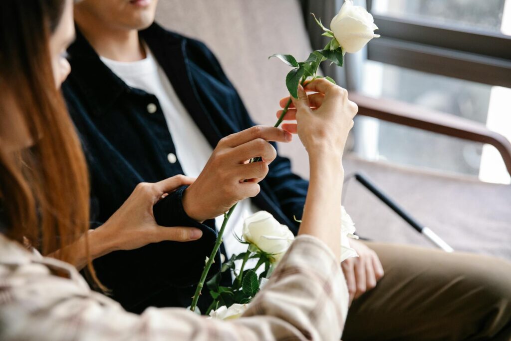Photo Of Couple Holding A White Flower
